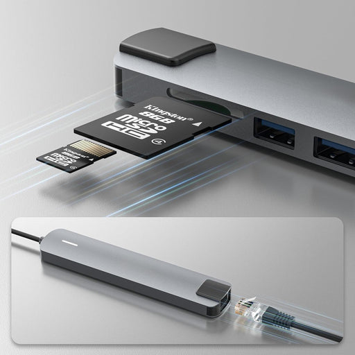 Multi-port adapter with microSD card and Ethernet cable on a reflective surface
